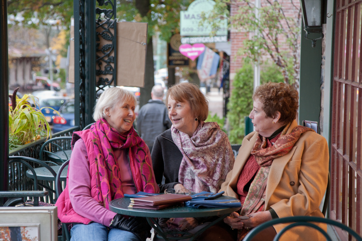 Three women sitting down at outdoor cafe