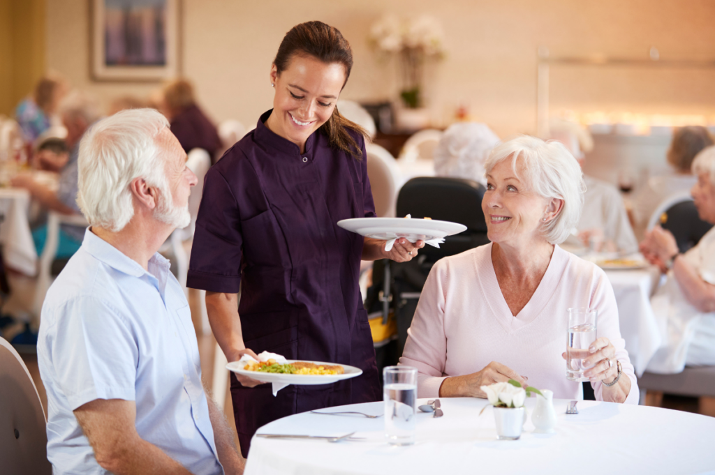 waiter delivering food in a senior living community